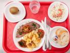 A typical canteen meal: a salad, roast beef with bakes potatoes and tomatoes, cheese with a fresh baguette and fruit (photo credit: Carine Duflos  hutterstock.com)