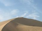 Huacachina, located near Ica, Peru, is the only natural desert oasis in South America, featuring enormous, 500-meter-high (1,600 ft) sand dunes