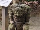 An Oni (demon) statue guarding a small pond