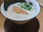 A bowl of concept ramen from the ramen museum, tonkotsu broth topped with smoked seafood foam!