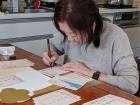 Baba writing New Year's greeting cards for friends and family