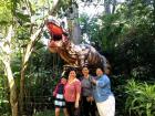 Mi familia tica posing in front of the T-Rex at Zoo Ave