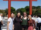 Posing with a parasol in my hand with friends in front of the giant 'torii', a Shinto shrine gate for the Tsurugaoka Hachiman-gu Shrine