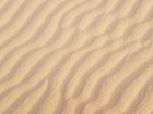 A wave-like pattern in the sand dunes after a heavy rainfall