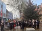 The town square of Reading (red-ing), England with a choir singing Christmas carols