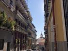 Cars lined up on a narrow street in Spain