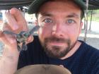 Another visitor holding up his baby sea turtle before he helps it to the sea