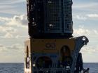 One of our ROVs suspended above the water, getting ready to dive down to the ocean bottom