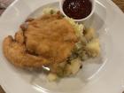 Řízek or schnitzel with potato salad and cranberries; this is actually a pretty small schnitzel... usually the schnitzel will cover the whole plate!