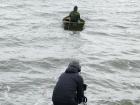 Eben Hopson checking his nets, and his catch