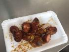 This is a Viennan streetfood called currywurst, which is a sausage doused in a barbecue-like sauce and given a shake of curry powder