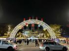 Sign reading "Merry Christmas" on a brightly lit arch