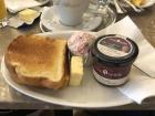 This is an example of a typical Viennese breakfast, which often consists of a cup of coffee, toast, jam, a boiled egg, ham, and cheese