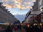 An outdoor market selling clothes, souvenirs, food and even paintings of the city