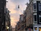 Sunset on a cobblestone street strung with lights