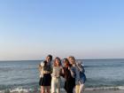 My friends and I doing a K-pop heart at the BTS bus stop beach