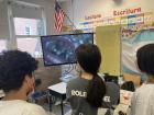 Students in a pop-up laboratory, examining earthworms with BioBus microscopes