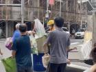People sorting their recycling and throwing away their trash at the trash truck