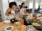 Amira stirs the sofrito, onion, garlic and peppers with chicken for our mixed paella!