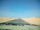 Many roads have sand dunes on both sides, and the wind blows sand into the road