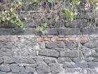 A line of bricks in between lava rocks