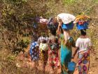 Women returning home after a day doing laundry along the river, Dindefelo, Senegal