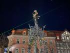 A student climbed to the top of the Gänseliesel statue and placed flowers at the top to celebrate