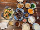 Dinner at my grandparents home with grilled fish and many side dishes