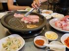 This is me grilling the meat on the barbeque surrounded by many side dishes