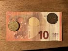 A ten euro bill and some coins