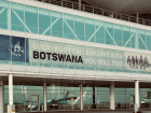 Banner at an airport reading "Everyone falls in love with Botswana. You will too." 