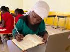 Nasara, an intelligent young girl from Tamale, practices writing