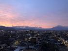 The sunset over Riobamba with volcanoes in the distance