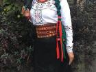 Traditional women's clothing, which often includes a black or navy skirt and a white blouse decorated with bright colors