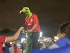 Tall dude giving out frog masks!
