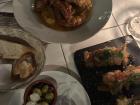 Bread with aioli spread, a mix of lobster and crab legs with vegetable spring rolls