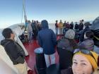 Scientists bundled up outside on a calm, but cold, day