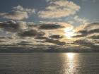 Sun peeking through approaching storm clouds