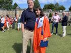 With my dad at my high school graduation on our football field--do you like my orange robe?!