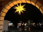An illuminated paper star hanging in the entrance to the Christmas market in Preetz