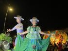 A float leading the parade showcasing the traditional dress of Panama, the gala pollera for women and the montuno for men 