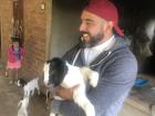 Sam hugging a baby goat