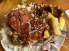 A delicious mix of pork, yuca, ensaladita, rice and ají sauce