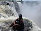 Sitting on the edge of the cliff at Victoria Falls
