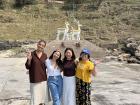 Standing in front of welcoming deer statue with friends at Daqiu Island