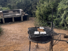Braai pits can be small and portable, like shown here in the front, or big permanent structures like in the back of this photo