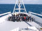 All of the voyage participants standing on the front deck