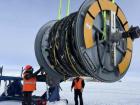 The cable spool is moved via crane lift (Delia Tosi, IceCube/NSF)
