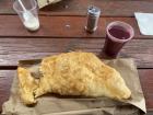 This is a fluffy empanada de pollo (chicken) with colada morada.
