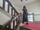 Yuyu going up the stairs in an old building
